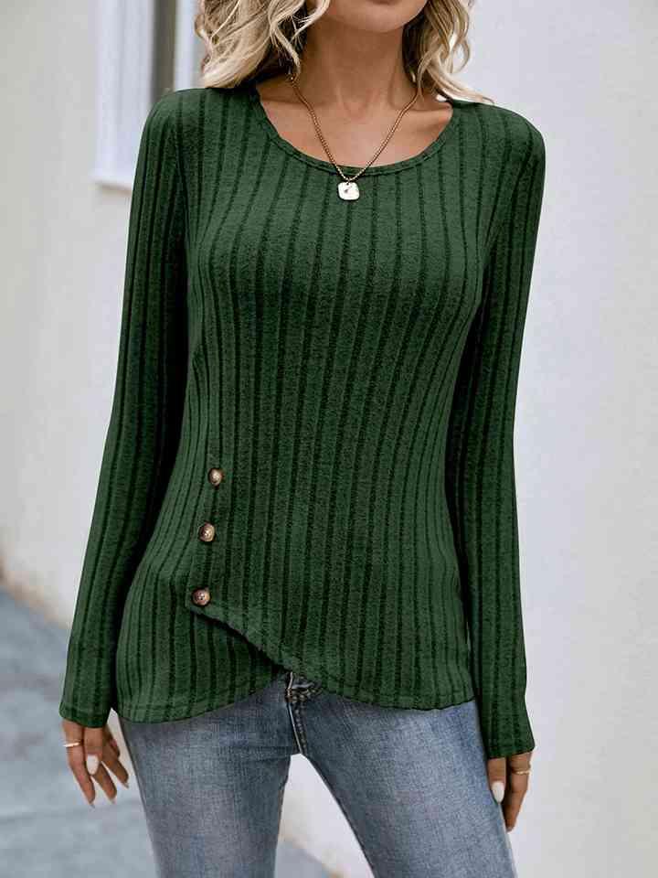 a woman wearing a green sweater and jeans