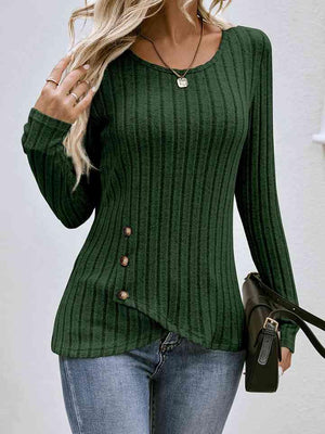 a woman wearing a green sweater and jeans