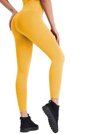 a woman in a yellow sports bra top and leggings