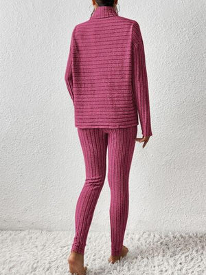 a woman in a pink sweater and pants