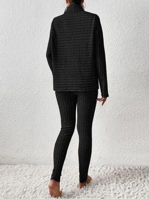 a woman wearing a black sweater and leggings