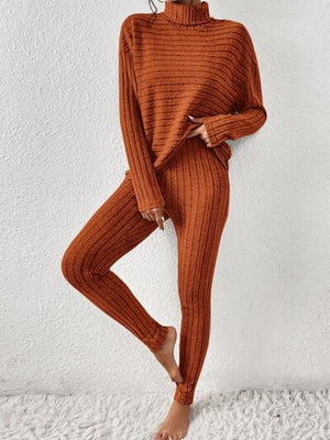 a woman in an orange sweater and pants