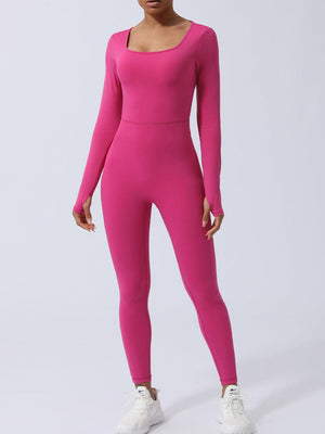 a woman in a pink bodysuit posing for the camera