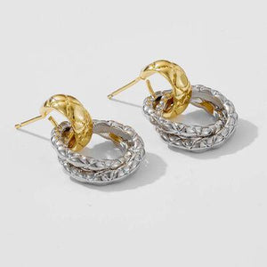 a pair of gold and silver earrings