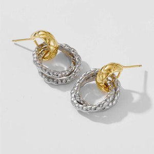 a pair of gold and silver hoop earrings