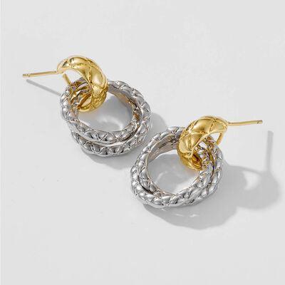 a pair of gold and silver hoop earrings