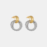 a pair of gold and silver earrings