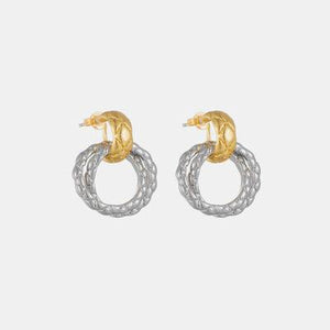 a pair of gold and silver earrings