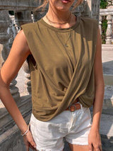 a woman standing in front of a stone wall