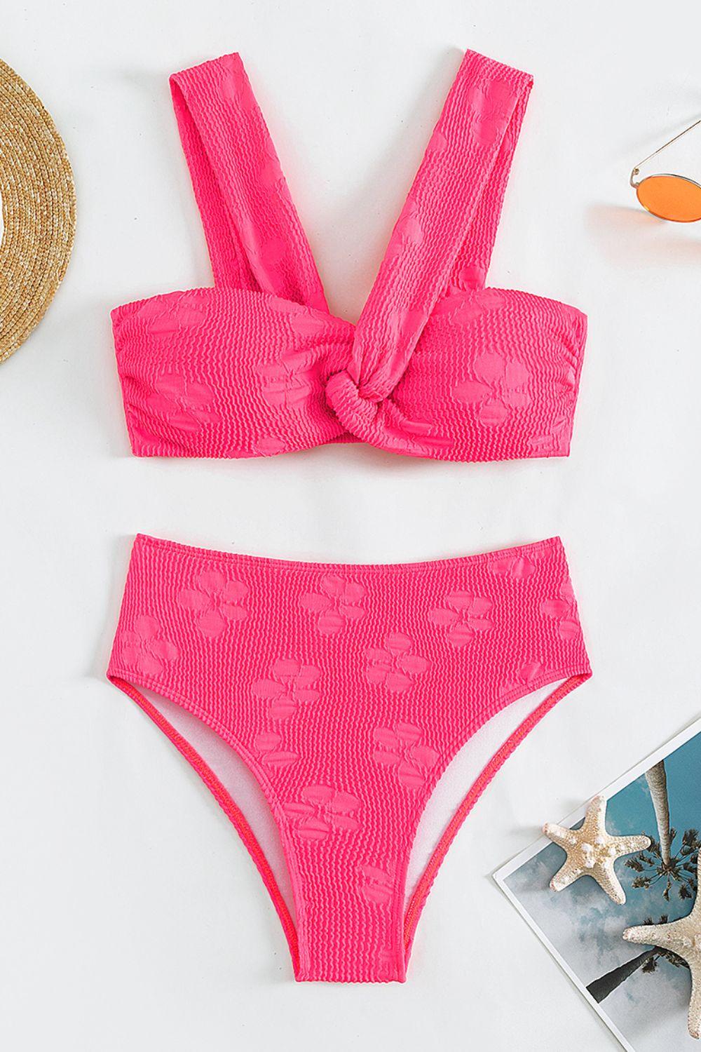 a pink bikinisuit with a bow on the side