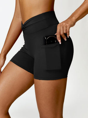 a woman in black shorts holding a cell phone