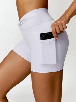 a woman in white shorts with a cell phone in her pocket