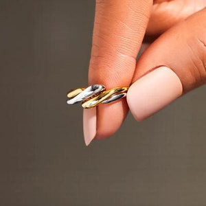 a woman's hand with two rings on it