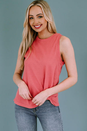 a woman in a pink top posing for a picture