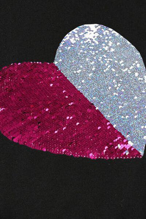 a heart shaped piece of sequins on a black background