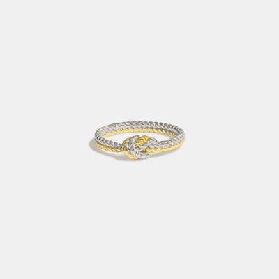 a white and yellow gold ring with a knot