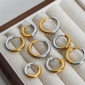 six pairs of gold and silver hoop earrings in a box