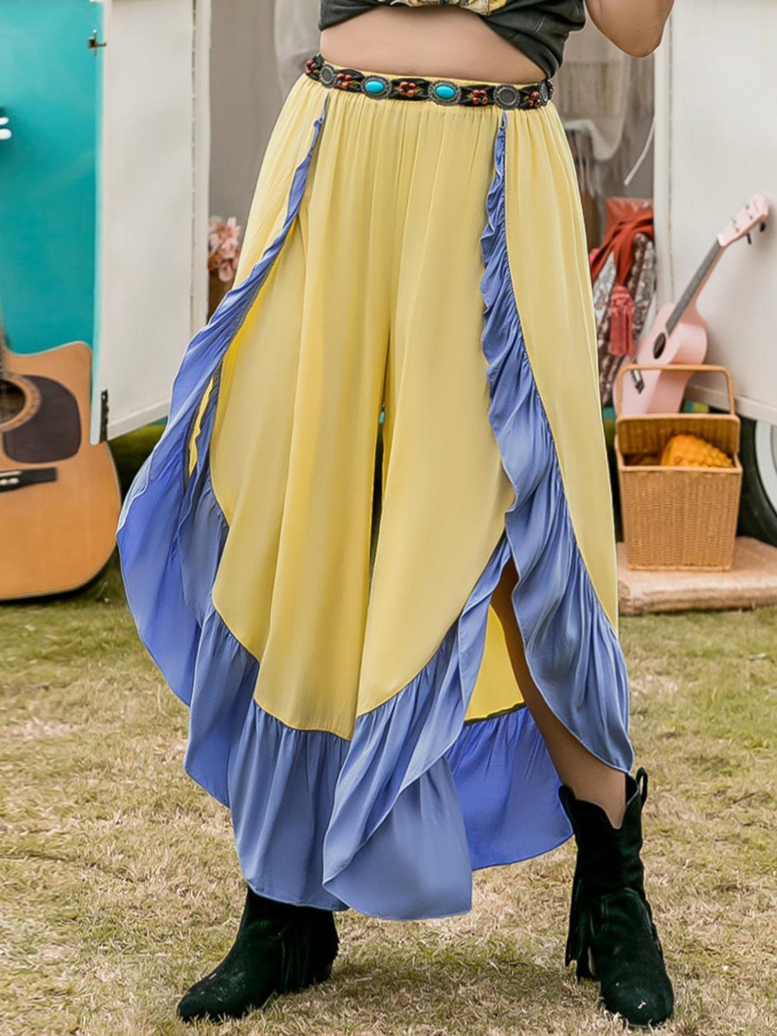 a woman in a long skirt holding a cell phone