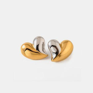 a pair of gold and silver earrings on a white background