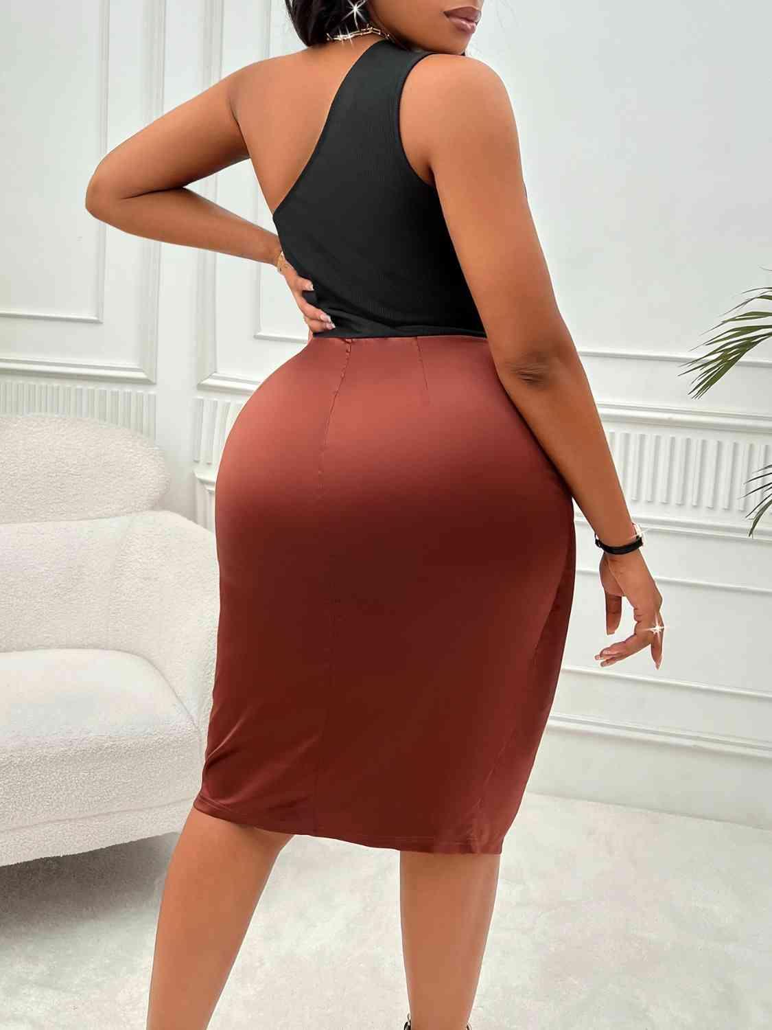 a woman in a black top and brown skirt