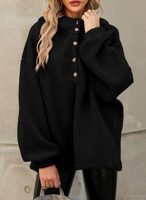 a woman wearing a black coat and black leggings