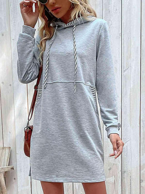 a woman wearing a grey hoodie dress