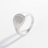 a silver ring with a flower on it