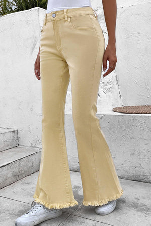 a woman in a white shirt and yellow pants