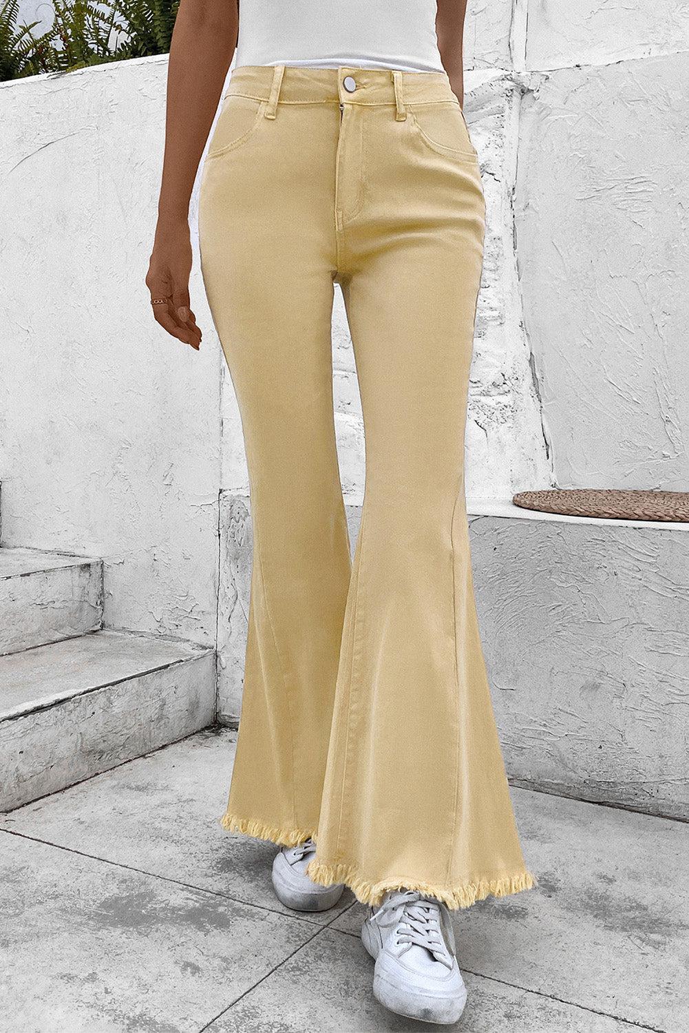 a woman in a white top and yellow pants