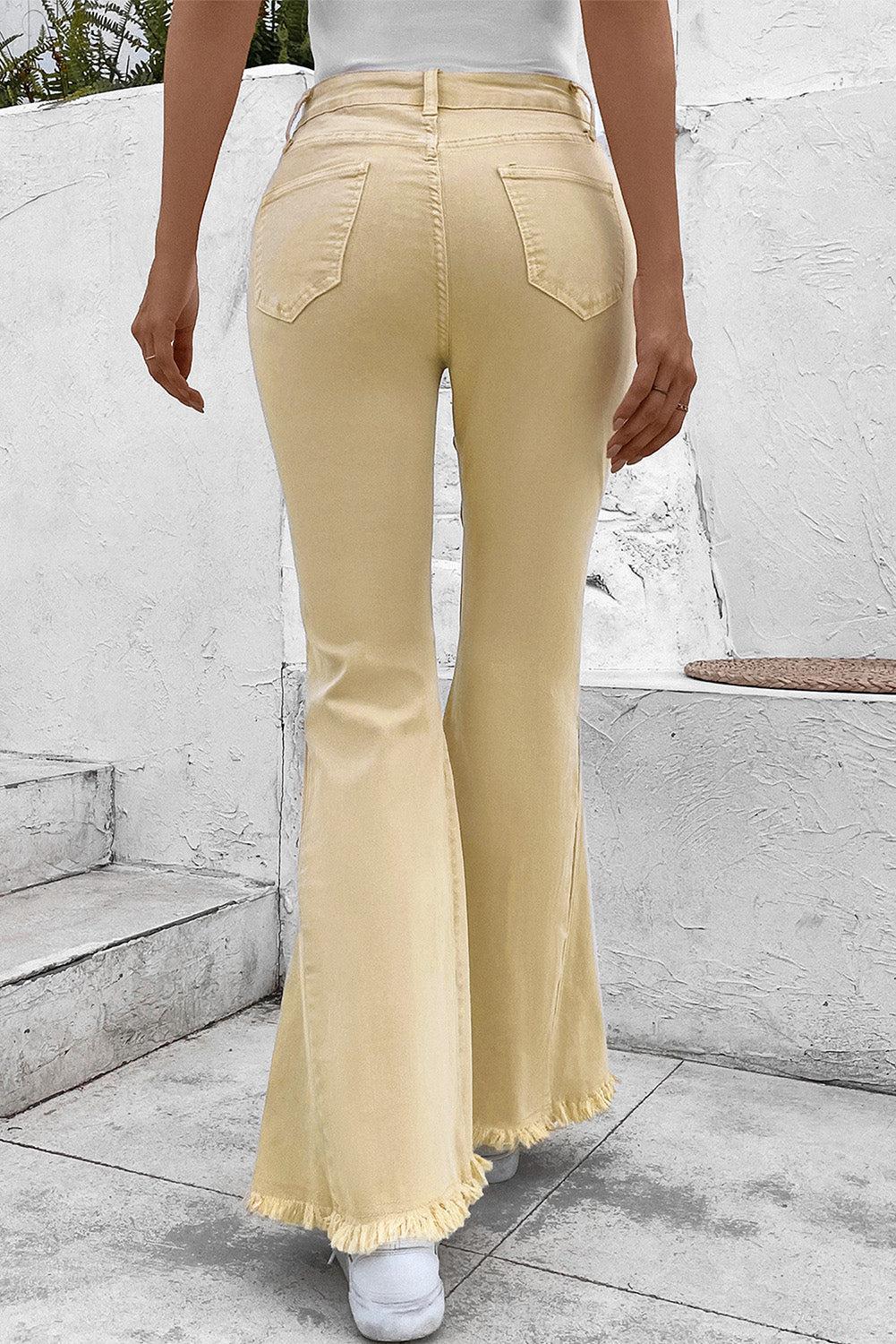 a woman in a white top and yellow pants