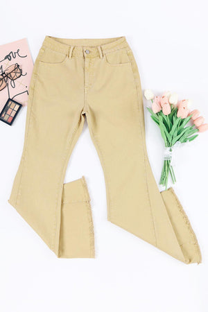 a pair of beige pants and a pink flower on a white background