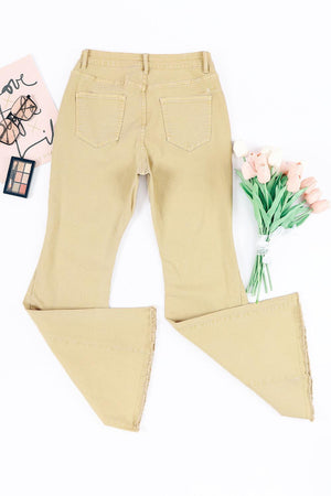 a pair of beige pants and a flower on a white background