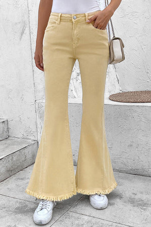 a woman in a white shirt and yellow pants