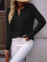 a woman wearing white pants and a black shirt