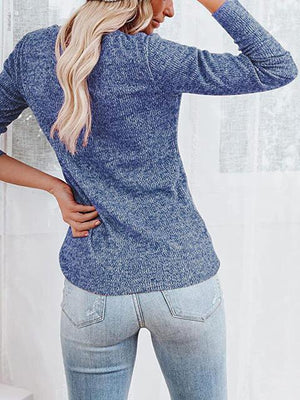 a woman wearing a blue sweater and jeans