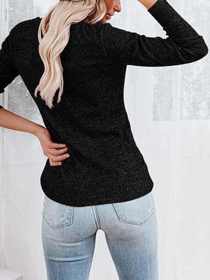 a woman wearing a black sweater and jeans