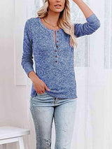 a woman wearing a blue top and ripped jeans