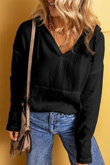 a woman wearing a black top and jeans