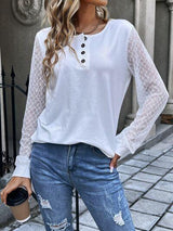 a woman wearing ripped jeans and a white top