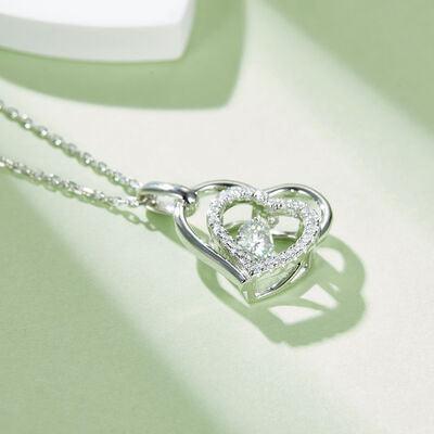 a heart shaped pendant with a diamond on a chain