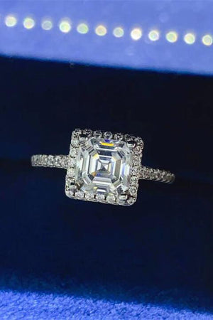 a diamond ring sitting on top of a blue velvet box