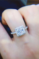 a close up of a person's hand with a diamond ring