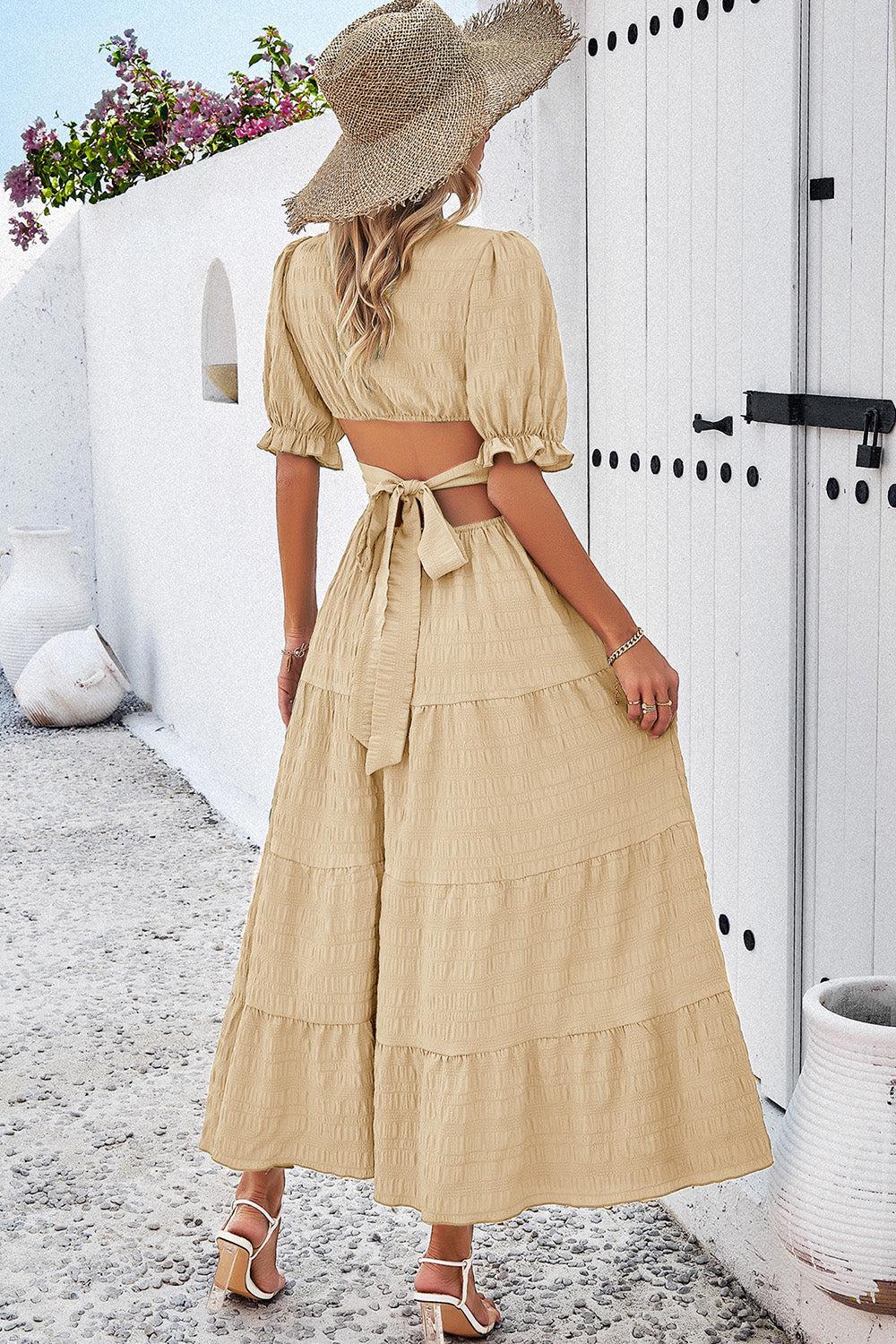 a woman in a dress and hat standing in front of a door