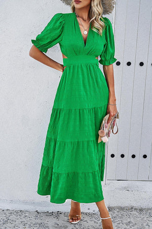 a woman wearing a green dress and hat