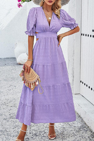 a woman wearing a purple dress and hat