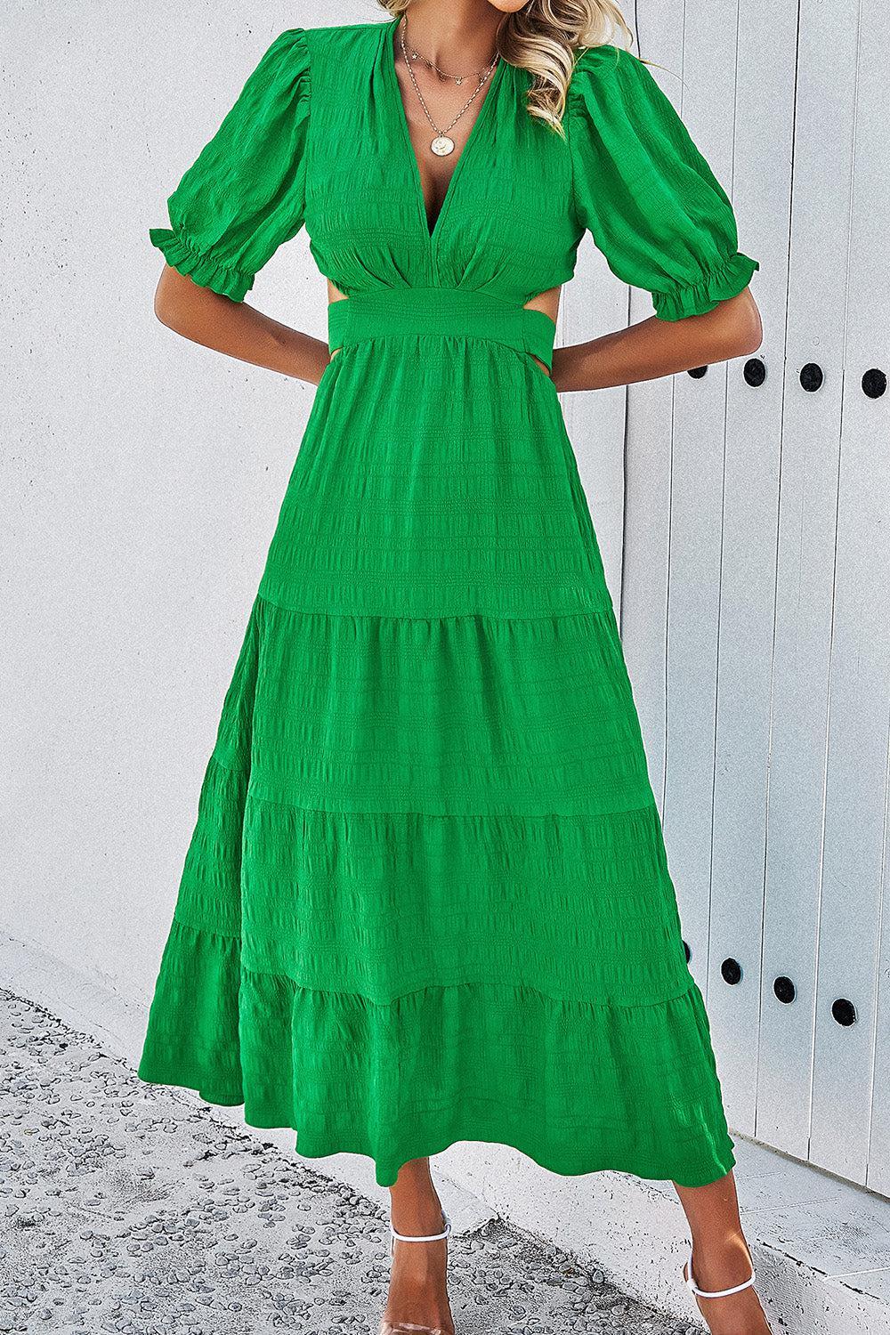 a woman in a green dress posing for a picture
