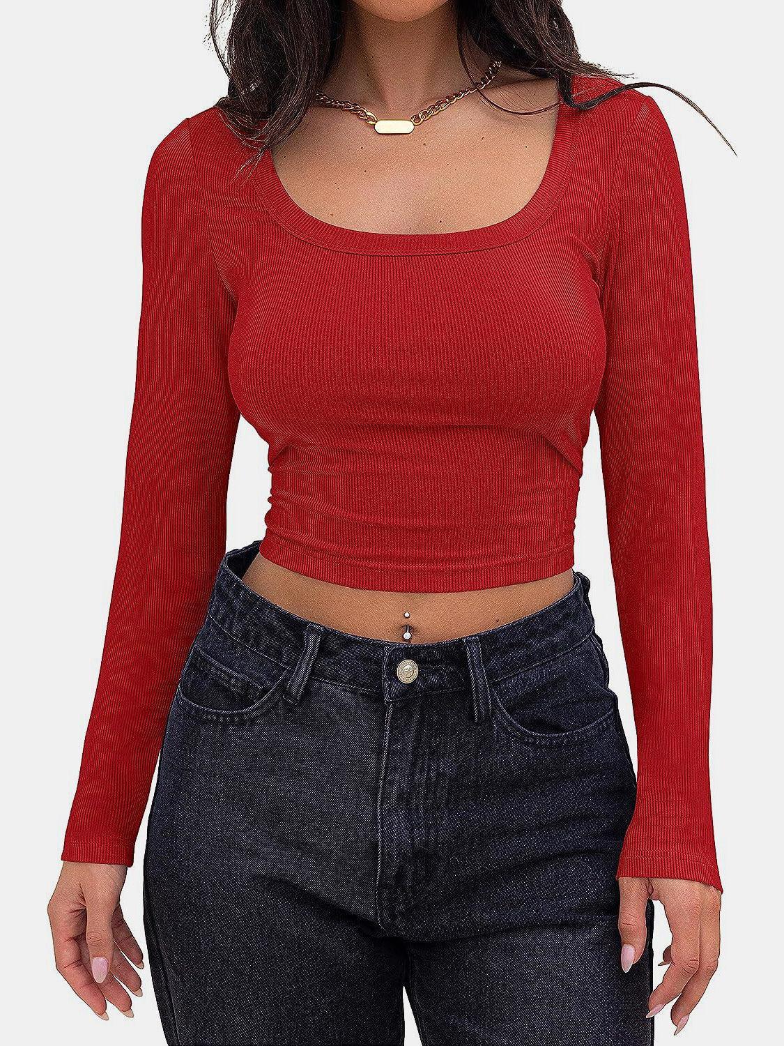 a woman wearing a red top and jeans