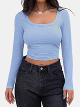 a woman wearing a blue top and jeans
