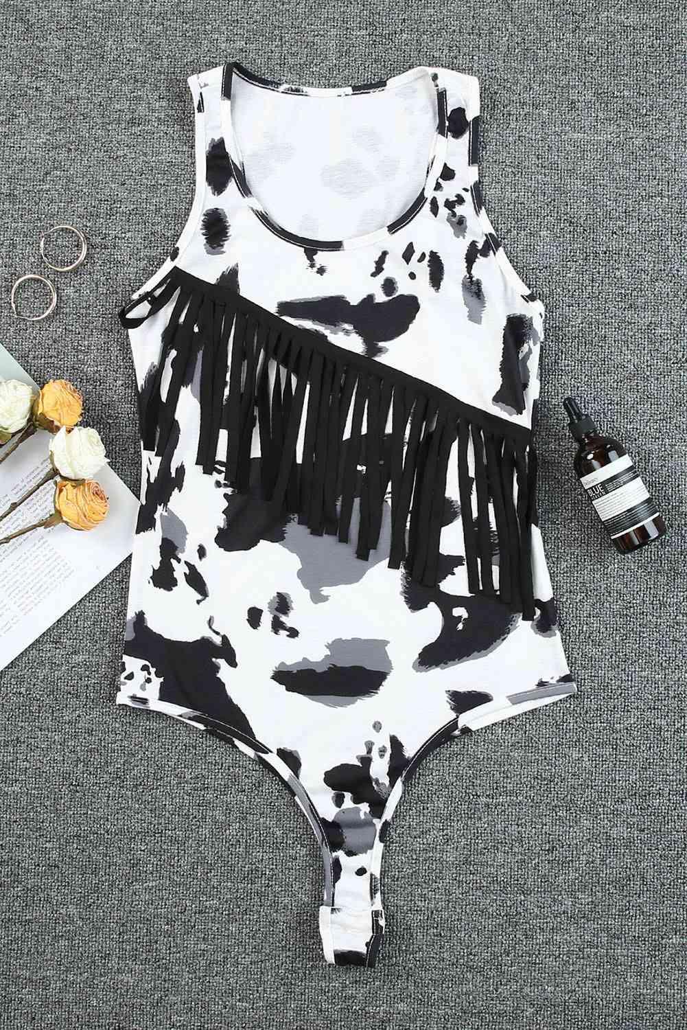 a bathing suit with a cow print and fringe detailing