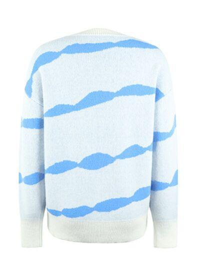 a white and blue sweater with blue waves on it